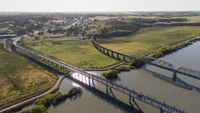 Aerial drone view of the road and rail bridges spanning the Murray River between Murray Bridge East and the agricultural floodplains of Long Flat in South Australia. Regional&nbsp;transport infrastructure.