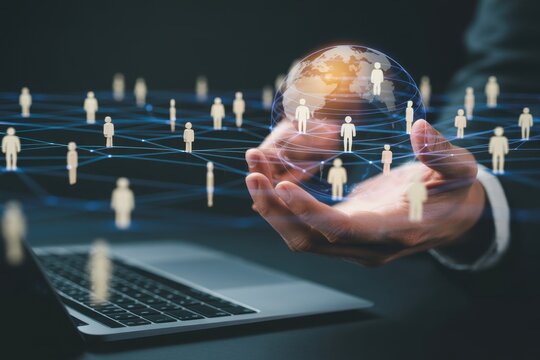 Businessman hand holding a glowing digital globe with interconnected network lines and human silhouette representing global business communication and data exchange