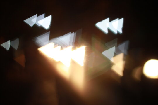 Abstract triangular bokeh lights glowing in dark night