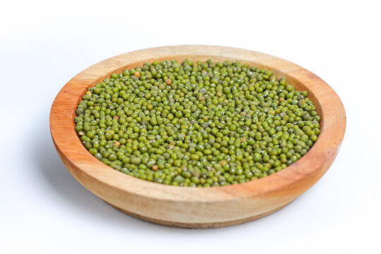 Green mung beans on wooden plate isolated on white