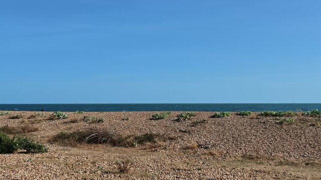 Hayling Island Hampshire England UK. 05.09.2026. Video. A wide landscape shot capturing a vast expanse of pebbles and stones along the coastline 