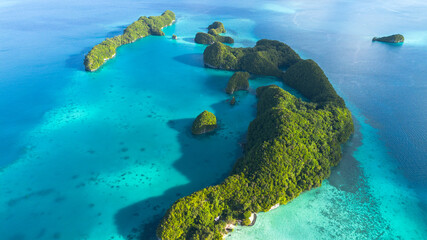 Aerial view of jungle-covered limestone islands and turquoise lagoon in the Rock Islands, Palau © Yuriko