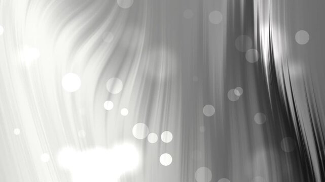 Abstract silver waves flowing with glowing bokeh particles