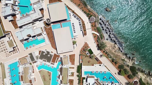 Overhead aerial view of Nana Royal Premium resort and Spa surrounding Crete sea waters