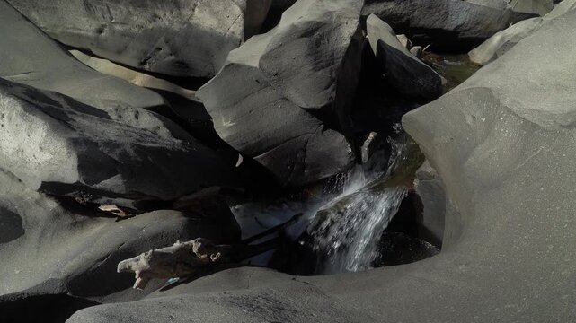 Vale da Lua water cascade flows through smooth weathered quartzite channels and rounded rock cavities along the Sao Miguel River in the Cerrado of Chapada dos Veadeiros, Alto Paraiso de Goias