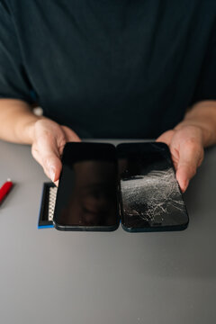 Concept of mobile device maintenance and electronic gadget repair service. Close-up of broken glass on display. Vertical shot with copy space on grey background, close-up, cropped shot