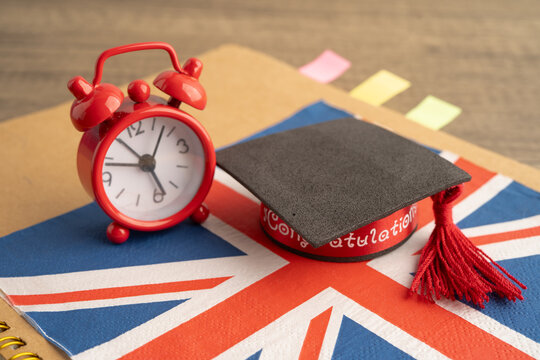 UK flag with graduate hat on english language book.