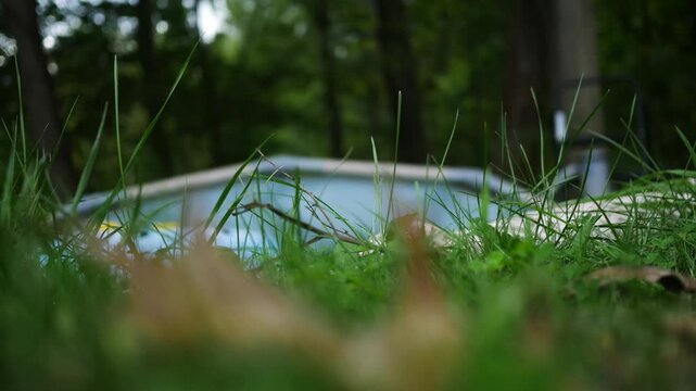  Deflated or Broken Pool Series - Dilapedated Pool Blurry with Grass Foreground