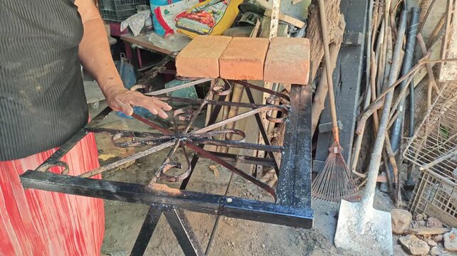 Adult Woman Arranging Heavy Bricks on Unstable Iron Frame Base
