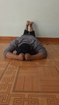Frustrated Young Man Kicking Wall and Hitting Floor in Emotional Breakdown