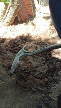 Stirring and Mixing Wet Soil Mud Mortar with Garden Shovel