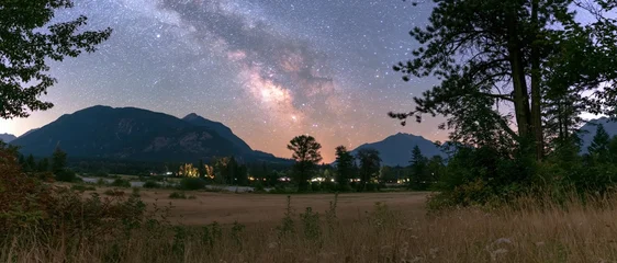 Milky Way Arching Over Mountain Range and Rural Field © arrin