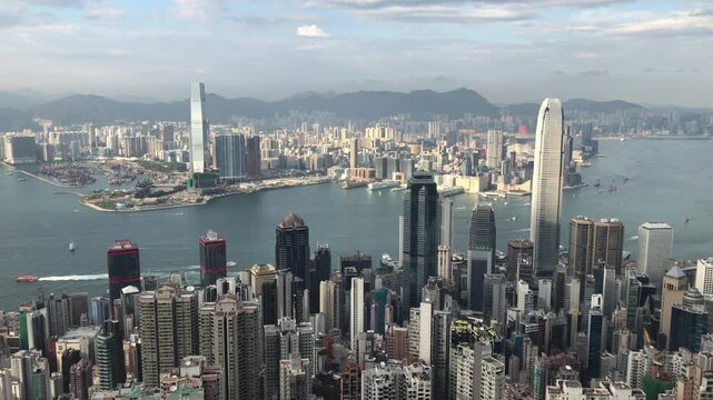 Overlooking Victoria Harbour from Victoria Peak, featuring Hong Kong's Central and Wan Chai districts, Kowloon Peninsula and Tsim Sha Tsui waterfront.