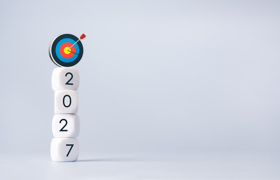 2027 number blocks topped with 3d bullseye and centered arrow. Annual goal achievement, strategic planning, business targets, performance objectives and focused success for the coming year concepts.