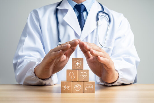 Doctor shelters wooden blocks showing medical care, heart health, exercise, nutrition and sleep, Whole-person preventive care, healthy lifestyle support and proactive health protection concept.