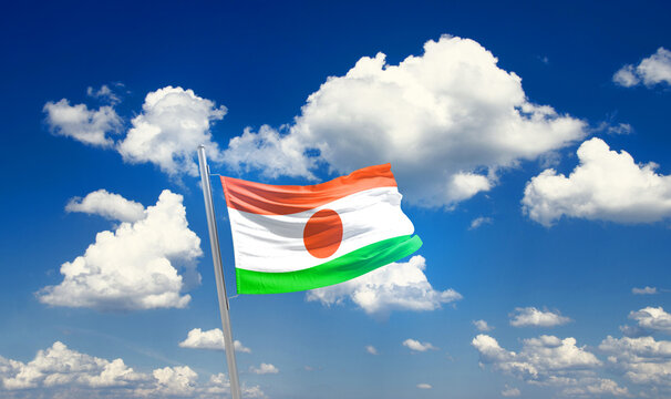 Niger national flag waving with skyline and buildings. Niger national flag for independence day.