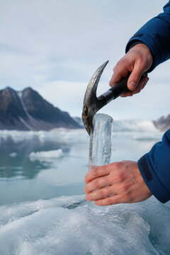 Hands Collecting Glacier Meltwater Sample
