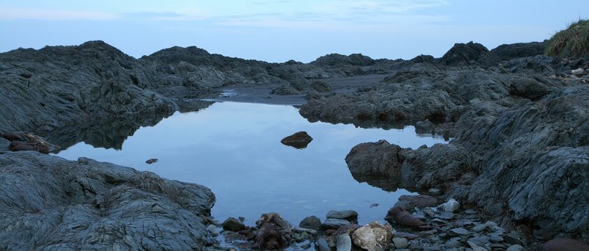 Rocky coastline with tide pool at dusk