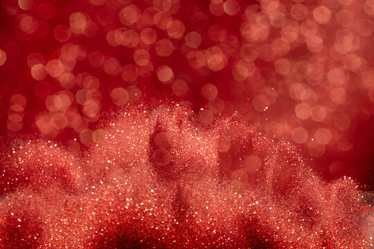 Abstract red glittering image evoked feelings of joy celebration. Background of red Sand powder glitter shimmered with golden sparkle, creating sparkling bokeh element wallpaper
