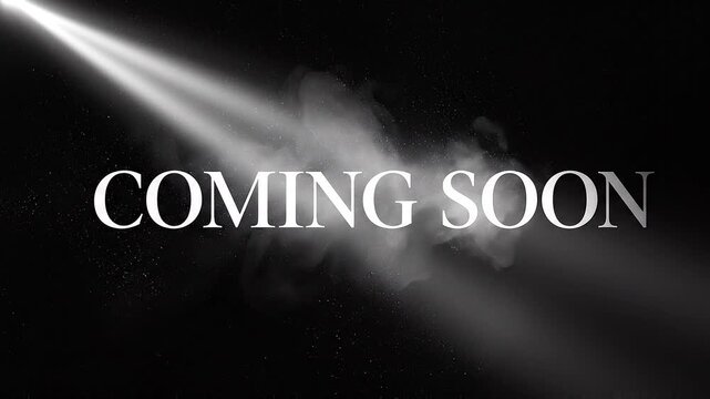 Coming soon text animation with spotlight beam and smoke dust on black background. Teaser motion graphics, grand opening reveal, and upcoming event title sequence stock video