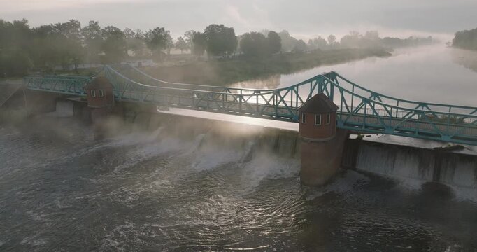 Bartoszowice bridge and weir in morning mist in Wrocław