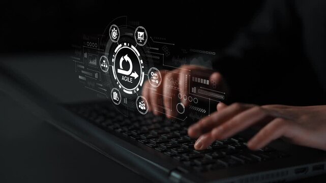 Hands Typing on a Laptop with Agile Project Management Interface Displayed in Front of the Keyboard in a Modern Digital Workspace. Entropy.
