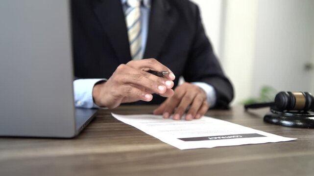 Lawyer reviewing legal documents and contracts, consulting clients on justice, legislation, court proceedings, government decisions, agreements, finance, and 