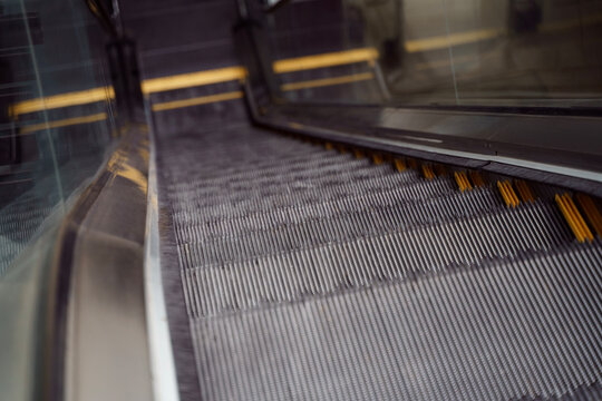 Empty shopping mall escalator and elevator button detail