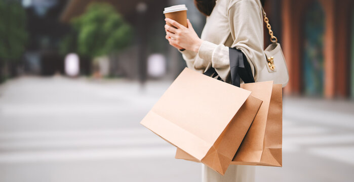 Single adult business asian woman holding coffee cup and shopping bag on black friday sale city people lifestyle