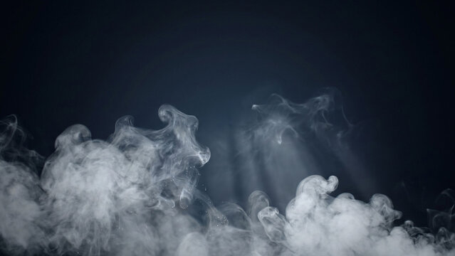 Dramatic white cloud of smoke over black background