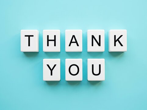 White letter blocks spelling Thank You on blue backdrop ideal for customer appreciation content symbolizing gratitude and polite acknowledgement