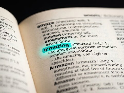Highlighted word amazing in an open dictionary page perfect for educational content symbolizing discovery excellence and positive vision