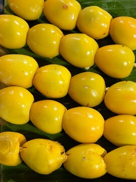 Close up yellow braised quail egg skewers, sate telur puyuh kuning on banana leaf, Indonesian street food in turmeric broth for culinary concepts