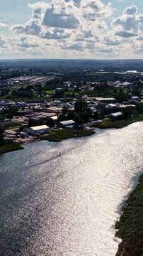 Gdańsk Refinery complex and surrounding suburbs along river, Poland, panoramic aerial perspective