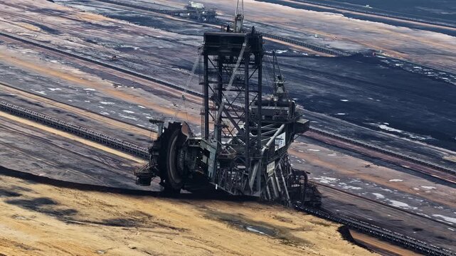 Aerial orbit reveals giant bucket wheel excavator working at Garzweiler open pit lignite mine Germany