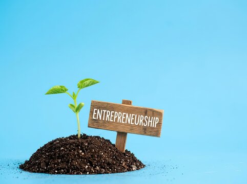 Green sprout emerging from soil next to an entrepreneurship sign ideal for business startup materials representing growth and new ideas