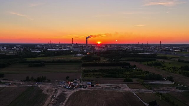 Industrial complex of the PKN ORLEN oil refinery in Płock, Poland, emitting fumes at dusk