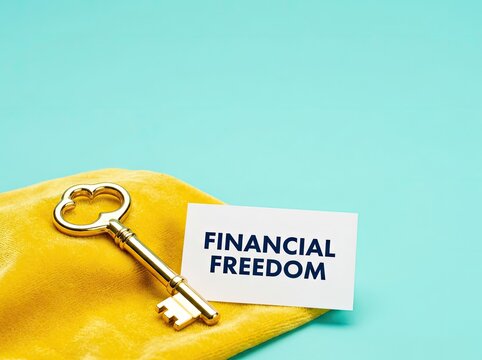 Golden key beside a financial freedom card suitable for wealth management campaigns symbolizing success independence and economic growth