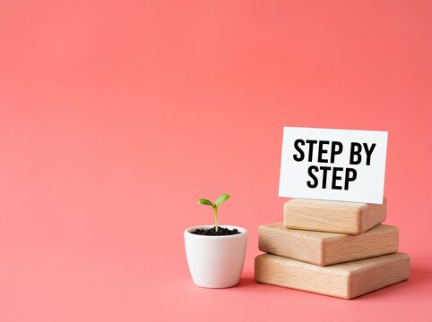 Small green sprout in pot next to step by step card on wooden block stack ideal for success content representing gradual personal growth