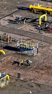 Industrial Natural Gas Facility With Yellow Gas Pipelines At The ORLEN Płock Production Plant In Płock, Mazovia, Poland. Vertical, Aerial Shot