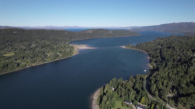 4K drone aerial view of Lake Nahuel Huapi from Cerro Campanario in Bariloche, R&iacute;o Negro, Argentina. Deep blue waters stretch across the Patagonian landscape surrounded by forested mountains.