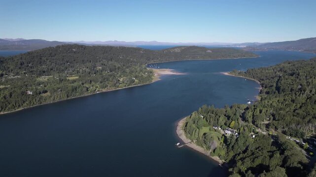 4K drone aerial view of Lake Nahuel Huapi from Cerro Campanario in Bariloche, R&iacute;o Negro, Argentina. Deep blue waters stretch across the Patagonian landscape surrounded by forested mountains.