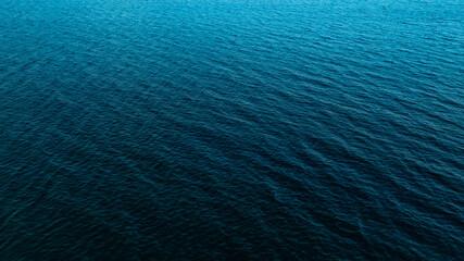 Naklejka premium Top view of deep blue sea water surface with small ripples, aerial drone shot of turquoise ocean texture at island , abstract nature background