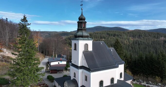 Aerial pull back from Maria Śnieżna Sanctuary on Igliczna in autumn