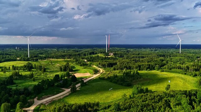 Aerial view showing wind turbines generating renewable power in a large rural green landscape