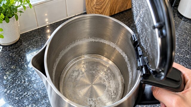 White limescale buildup inside electric kettle