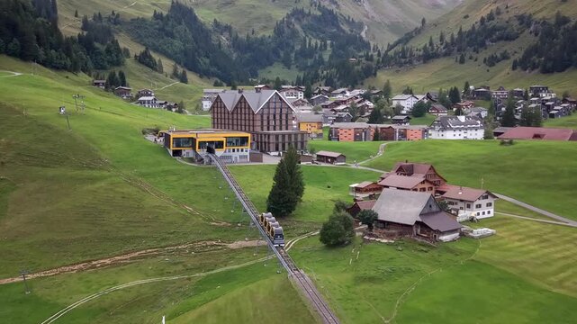 Aerial shot of Stoos funicular arriving at alpine village station