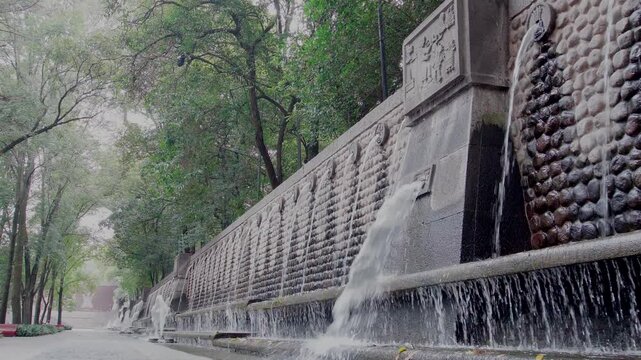 Amazing ancient fountain Chapultepec park Mexico city aztec symbol water running green trees daylight
