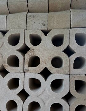 Stack of decorative concrete breeze blocks with geometric ventilation holes pattern for modern wall architecture