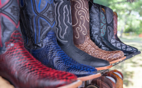 Mexico, Texas United State. Multicolor leather cowboy boots neatly displayed a store shelf.